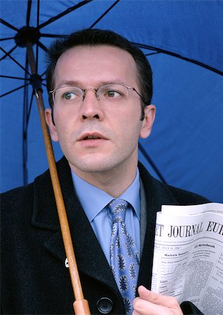 paper umbrella - Man holding umbrella and newspaper, portrait Stock Photo - Premium Royalty-Free, Code: 695-03381218
