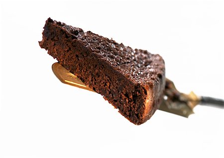 simsearch:614-03191356,k - Piece of chocolate cake on cake server, close-up, white background Stock Photo - Premium Royalty-Free, Code: 695-03381297