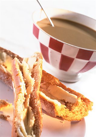 Bowl of chocolate and pieces of bread with butter, close-up Stock Photo - Premium Royalty-Free, Code: 695-03381318