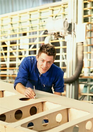 simsearch:614-05557261,k - Man in coveralls behind woodwork, looking into camera, head and shoulders Stock Photo - Premium Royalty-Free, Code: 695-03381566