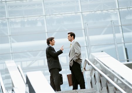 Two businessmen standing at the top of stairs Foto de stock - Sin royalties Premium, Código: 695-03381620