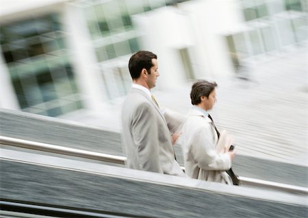 stressed guy working late - Two businessmen walking down stairs, blurred Stock Photo - Premium Royalty-Free, Code: 695-03381621