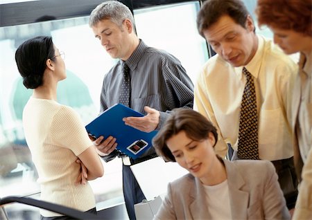 Group of business people standing and talking Stock Photo - Premium Royalty-Free, Code: 695-03381632