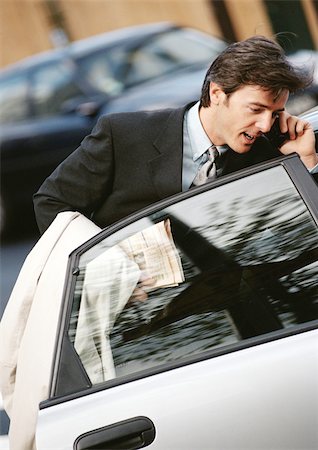 simsearch:696-03398874,k - Businessman behind opened car door, using cell phone Stock Photo - Premium Royalty-Free, Code: 695-03381640