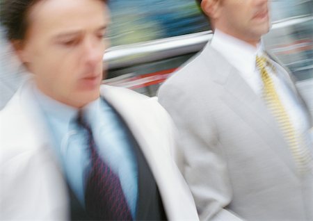 simsearch:695-03381608,k - Two businessmen walking outside, close-up, blurred Foto de stock - Sin royalties Premium, Código: 695-03381660