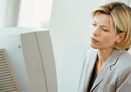 Businesswoman at computer screen Stock Photo - Premium Royalty-Free, Code: 695-03381674