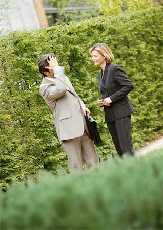 Businessman and businesswoman talking in park Stock Photo - Premium Royalty-Free, Code: 695-03381739