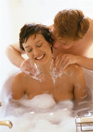 pictures women bathing men bathroom - Woman taking bath, man massaging her shoulders Stock Photo - Premium Royalty-Free, Code: 695-03381849