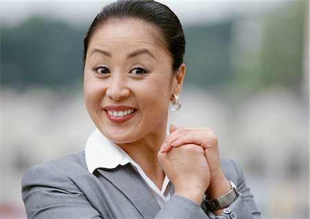 dynamic business - Businesswoman smiling, hands together, portrait Stock Photo - Premium Royalty-Free, Code: 695-03381950