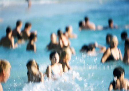 People standing waist-deep in water at beach, blurred Stock Photo - Premium Royalty-Free, Code: 695-03382228
