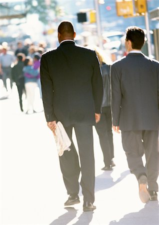 Two businessmen walking in street, rear view Stock Photo - Premium Royalty-Free, Code: 695-03382288