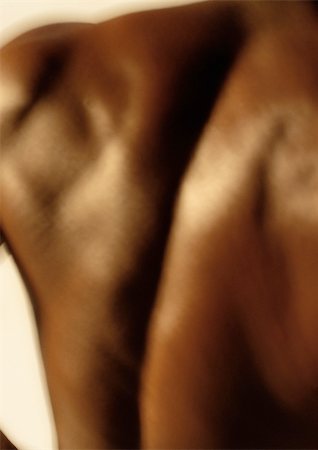 Man's bare back, close up, blurred Stock Photo - Premium Royalty-Free, Code: 695-03382446