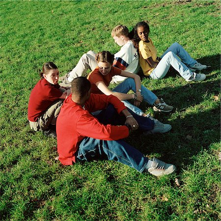 Young people sitting on grass, high angle view Stock Photo - Premium Royalty-Free, Code: 695-03382478