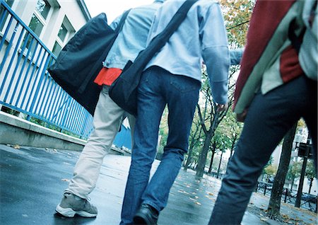 simsearch:695-03383828,k - Young people walking down sidewalk, lower section, rear view Stock Photo - Premium Royalty-Free, Code: 695-03382604