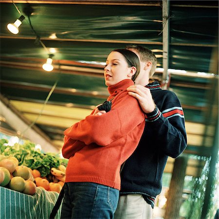 Young couple next to produce at market, low angle view Stock Photo - Premium Royalty-Free, Code: 695-03382607