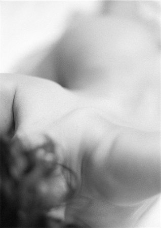 Nude woman, close-up of neck and shoulders, high angle view, black and white Stock Photo - Premium Royalty-Free, Code: 695-03382718