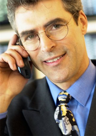 simsearch:696-03398874,k - Businessman wearing glasses using cellular phone, close-up, portrait. Stock Photo - Premium Royalty-Free, Code: 695-03382797