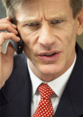 simsearch:400-07827131,k - Businessman using cellular phone, close-up portrait. Stock Photo - Premium Royalty-Free, Code: 695-03382801