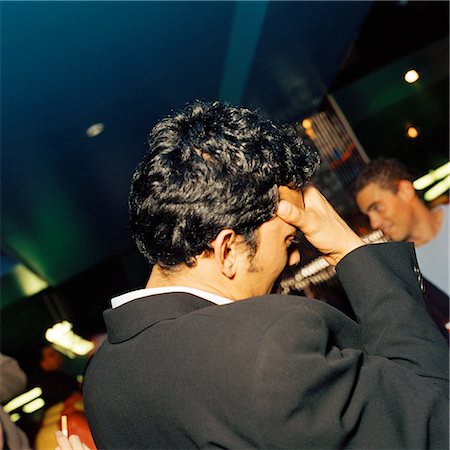 Young man holding head in bar, rear view. Foto de stock - Sin royalties Premium, Código: 695-03382878