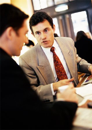 simsearch:696-03398874,k - Businessmen talking together, close-up Stock Photo - Premium Royalty-Free, Code: 695-03382914