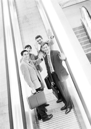 simsearch:695-03382908,k - Group of business people waving at camera, blurred, b&w. Fotografie stock - Premium Royalty-Free, Codice: 695-03382911