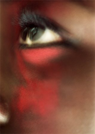 simsearch:695-03383093,k - Woman's eye looking up with red make-up on face, close-up, blurred Foto de stock - Sin royalties Premium, Código: 695-03383100