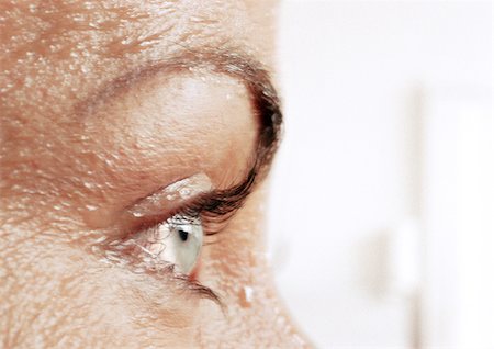 Woman's eye and wet skin, close-up, side view Stock Photo - Premium Royalty-Free, Code: 695-03383145