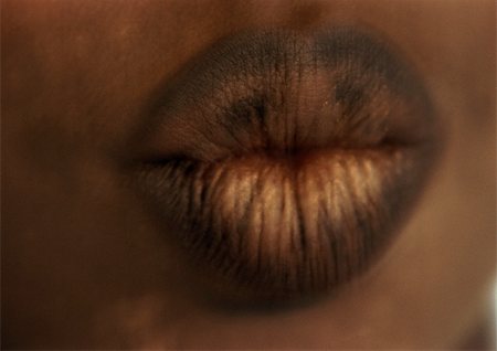 Woman wearing dark lipstick, close up of puckered lips, blurred Stock Photo - Premium Royalty-Free, Code: 695-03383170
