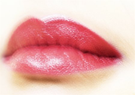 simsearch:695-03388448,k - Woman's mouth with lipstick, blurred, extreme close-up Fotografie stock - Premium Royalty-Free, Codice: 695-03383206