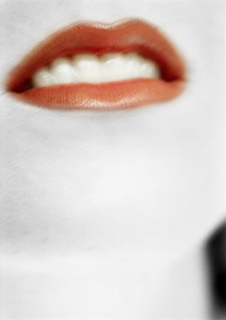 Woman wearing red lipstick, close up of mouth, blurred. Stock Photo - Premium Royalty-Free, Code: 695-03383236