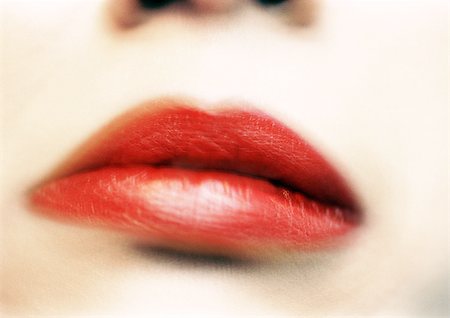 Woman's mouth with red lipstick, blurred, extreme close-up Stock Photo - Premium Royalty-Free, Code: 695-03383245