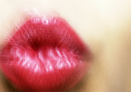 Close up of woman's mouth puckering, blurry. Stock Photo - Premium Royalty-Free, Code: 695-03383276