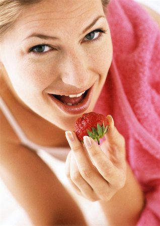 simsearch:696-03400445,k - Woman eating strawberry, low angle view, close-up Stock Photo - Premium Royalty-Free, Code: 695-03383593