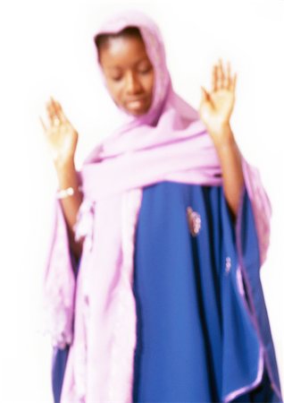 Muslim woman with hands up in prayer, blurry. Stock Photo - Premium Royalty-Free, Code: 695-03383621