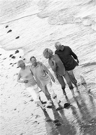 Two mature couples walking down the beach together, view from above, B&W Stock Photo - Premium Royalty-Free, Code: 695-03383699