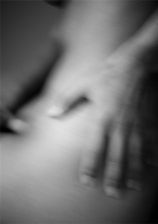 Woman's hand on bare hip, close-up, blurred, B&W Stock Photo - Premium Royalty-Free, Code: 695-03383958