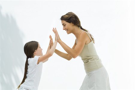 simsearch:633-02066083,k - Mother and daughter playing clapping game together Stock Photo - Premium Royalty-Free, Code: 695-03390005