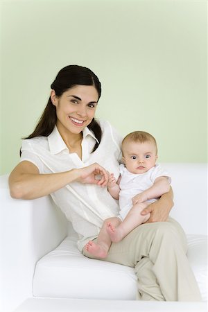 simsearch:695-03390320,k - Woman holding baby on her lap, smiling at camera Foto de stock - Sin royalties Premium, Código: 695-03390063