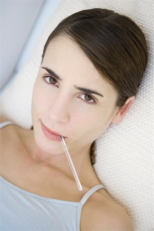 Woman with thermometer in her mouth, close-up Stock Photo - Premium Royalty-Free, Code: 695-03390123