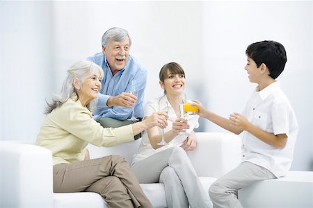 family hispanic not two people not baby not outdoors not caucasian - Multi-generation family clinking glasses, smiling at each other Stock Photo - Premium Royalty-Free, Code: 695-03390230