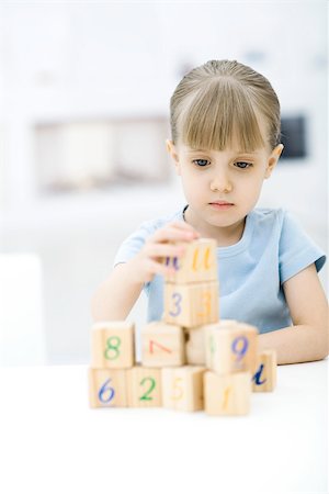 Little girl stacking blocks Stock Photo - Premium Royalty-Free, Code: 695-03390246