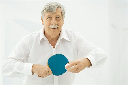 plain background - Senior man playing table tennis Stock Photo - Premium Royalty-Free, Code: 695-03390316