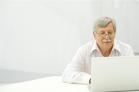 simsearch:693-06378950,k - Senior man using laptop computer Stock Photo - Premium Royalty-Free, Code: 695-03390311