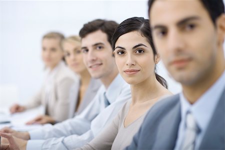 simsearch:632-03779793,k - Professionals lined up, smiling at camera, selective focus Foto de stock - Royalty Free Premium, Número: 695-03390351