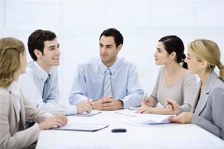 simsearch:695-03380508,k - Businessman sitting with colleagues at conference table Stock Photo - Premium Royalty-Free, Code: 695-03390352