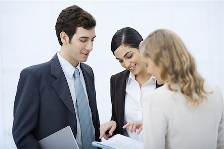 simsearch:632-03779792,k - Business associates looking at document together Stock Photo - Premium Royalty-Free, Code: 695-03390360