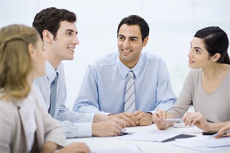 simsearch:695-03380508,k - Businessman sitting with colleagues at conference table Stock Photo - Premium Royalty-Free, Code: 695-03390362