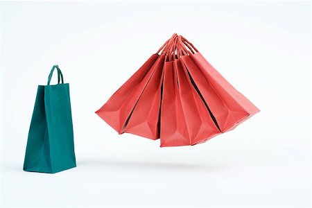 shop to play - Group of red shopping bags floating in midair beside single blue bag Stock Photo - Premium Royalty-Free, Code: 695-03390397