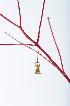 simsearch:695-03390449,k - Miniature Buddha ornament hanging from bare branch Foto de stock - Sin royalties Premium, Código: 695-03390415