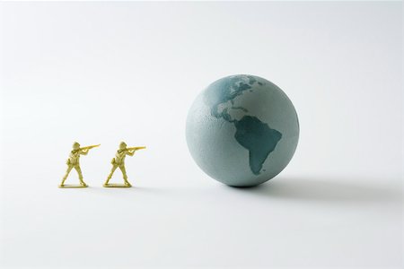 estatueta - Toy soldiers aiming guns at the Earth Foto de stock - Royalty Free Premium, Número: 695-03390421